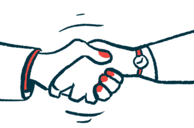 Two hands are seen clasped together in a handshake.