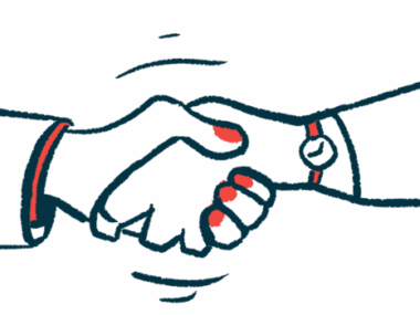 Two hands are seen clasped together in a handshake.