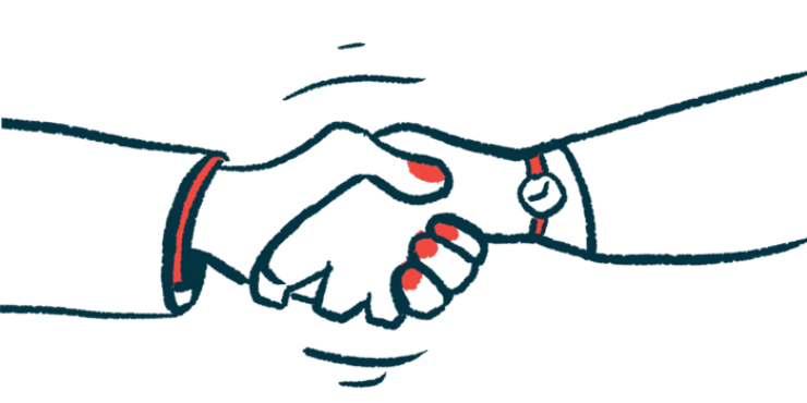 Two hands are seen clasped together in a handshake.