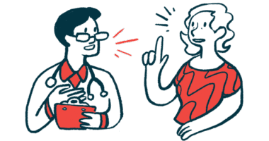 A woman gestures with one hand while speaking with a clinician, who holds a clipboard.