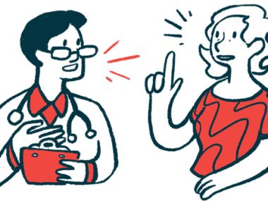 A woman gestures with one hand while speaking with a clinician, who holds a clipboard.